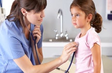 A young girl visits a doctor.