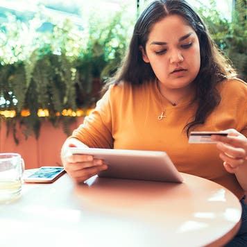 woman shopping online with a credit card