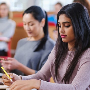 College students take notes in a classroom