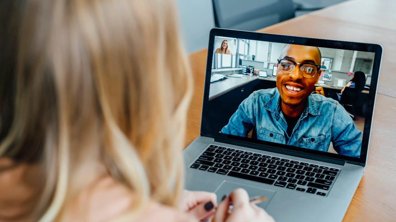 Business people chat on a video conference call.