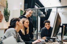 A group of colleague discuss over a computer