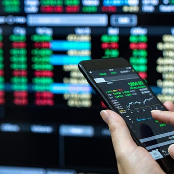 A trader looks at his phone for bond prices