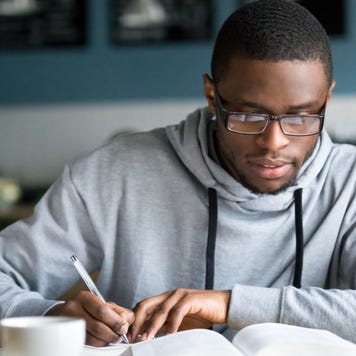 Student works on homework at coffee shop.