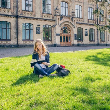 Young woman studies on college campus.