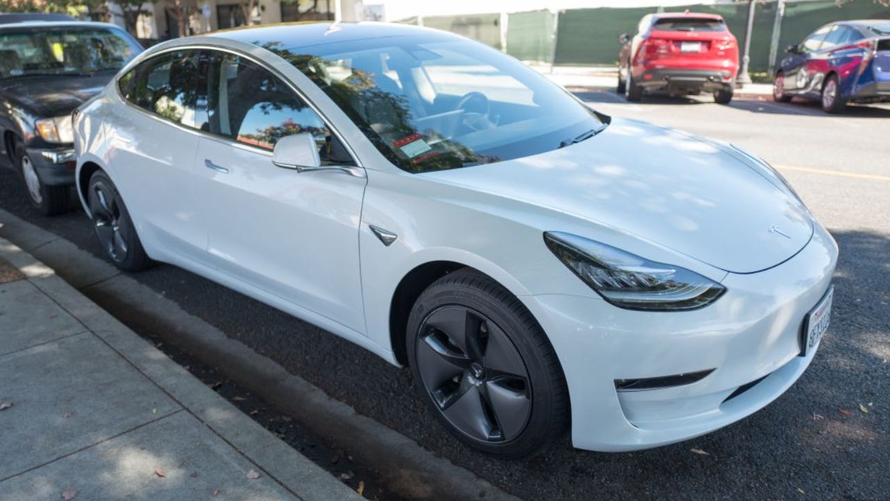 Shot of a white Tesla parked along the street