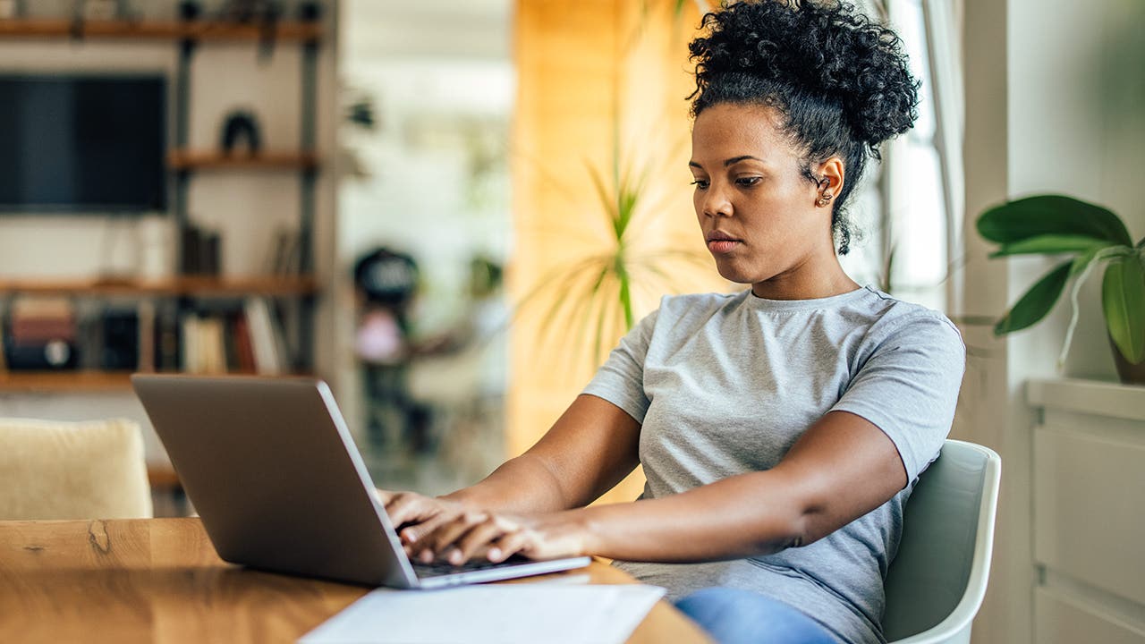 adult women working on her computer sitting down