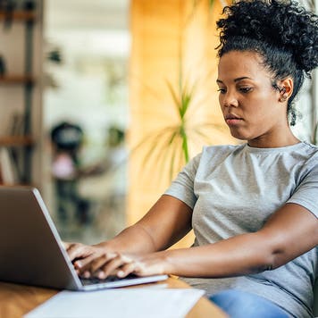 adult women working on her computer sitting down