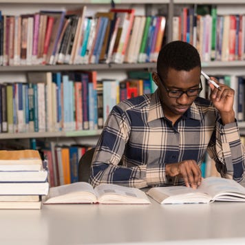 College student studying in library.