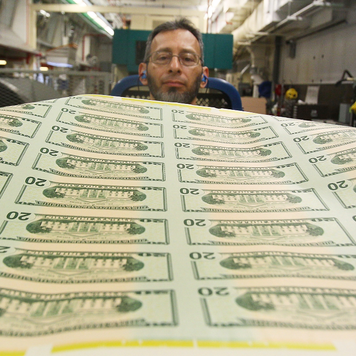 Freshly printed $20 bills are inspected at the Bureau of Engraving and Printing