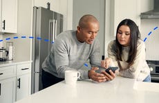 teenager and parent looking at iphone