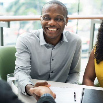 A couple meets with their lender to close on their mortgage