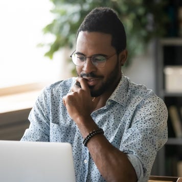 Man researches on a laptop.