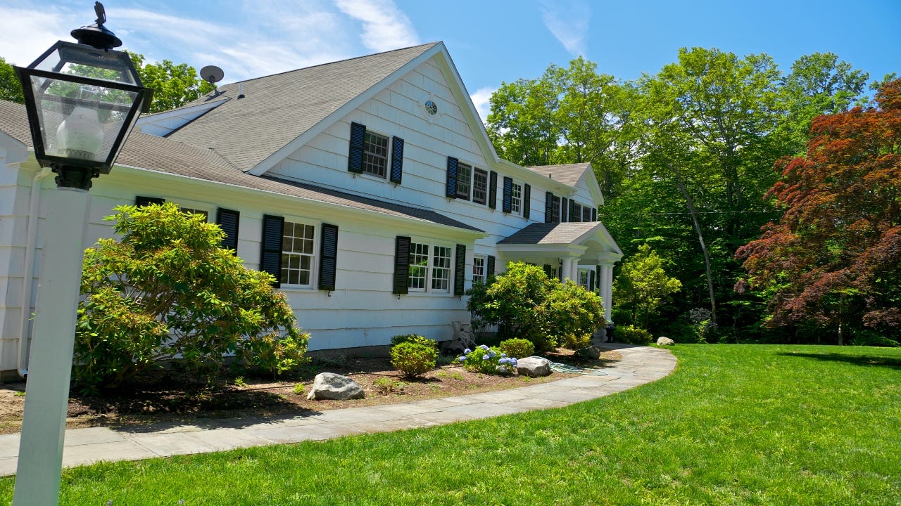 An exterior of a home and yard