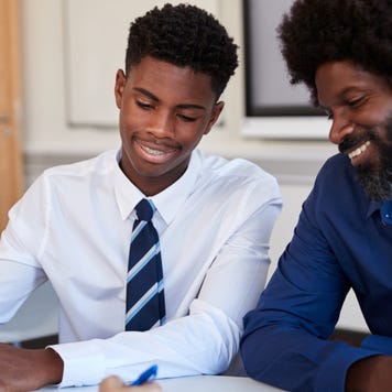 Father and son look over documents together.