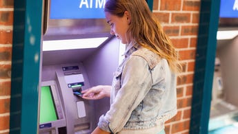 A student withdraws cash at an ATM.