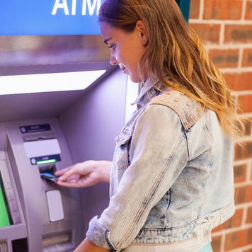 A student withdraws cash at an ATM.