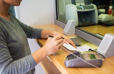 customer filling out paperwork at the bank