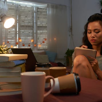 College student studies in dorm room.