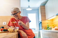 A retiree at home eating lunch
