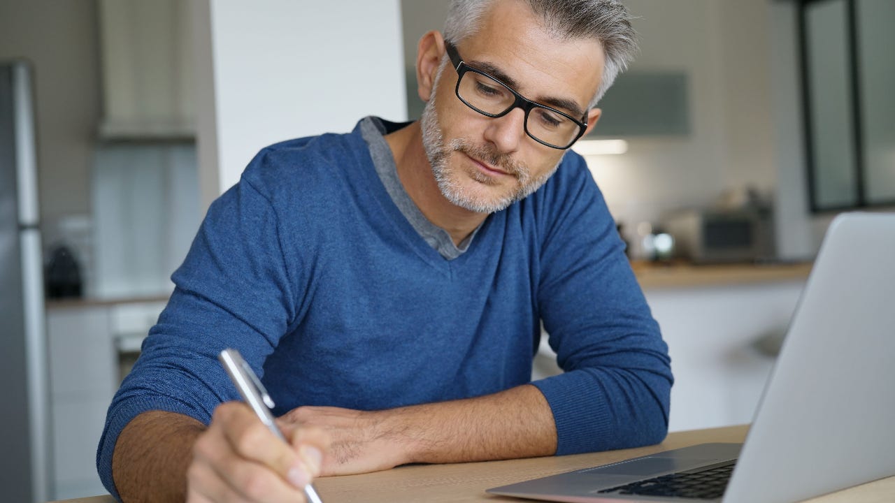 A man researches online.