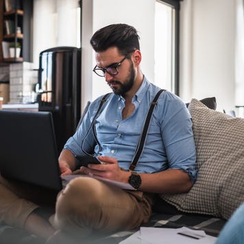 Man works on computer at home.