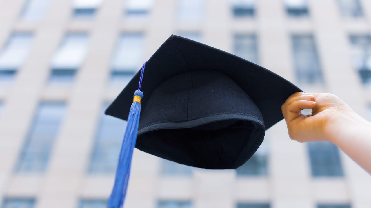 Graduation cap with university building