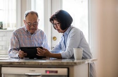 Couple using tablet at home