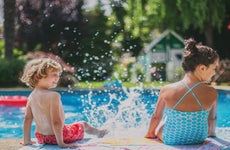 Two children splash by the pool.