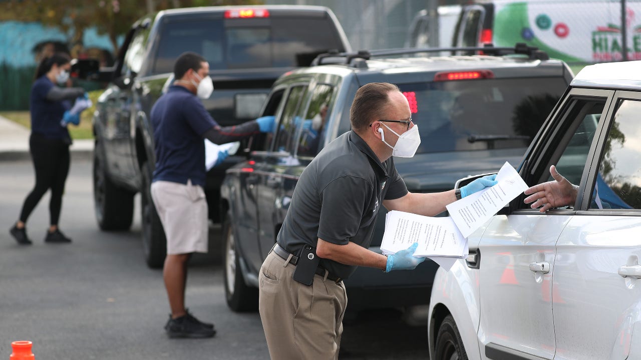 Employees hadn out unemployment applications to people in their vehicles