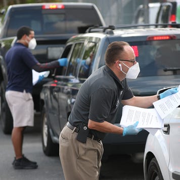 Employees hadn out unemployment applications to people in their vehicles