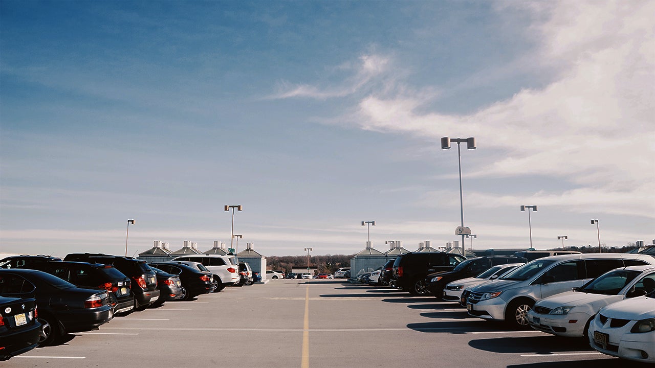 Cars Parked At Parking Lot Against Sky