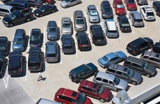 Aerial view of automobiles parked in symmetrical pattern