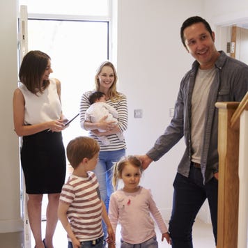 A real estate agent gives a tour of a home