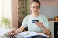 Young woman uses credit card to make online purchase