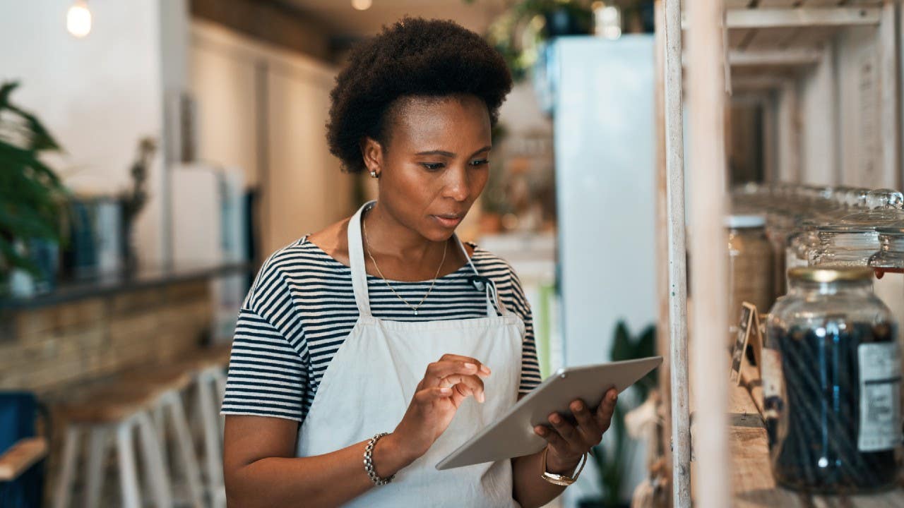 Black female business owner using tablet