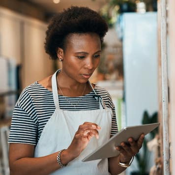 Black female business owner using tablet