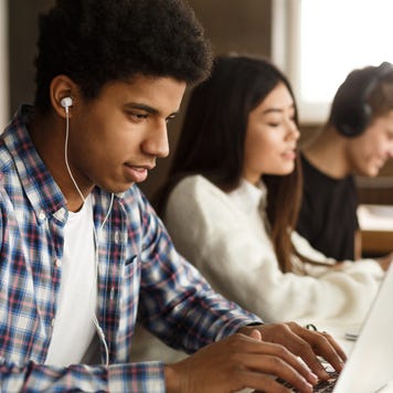 High school students study on laptops