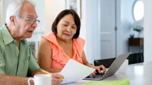 A White man and Asian woman discuss finances