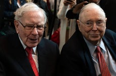 Warren Buffett and Charlie Munger attend a shareholders meeting