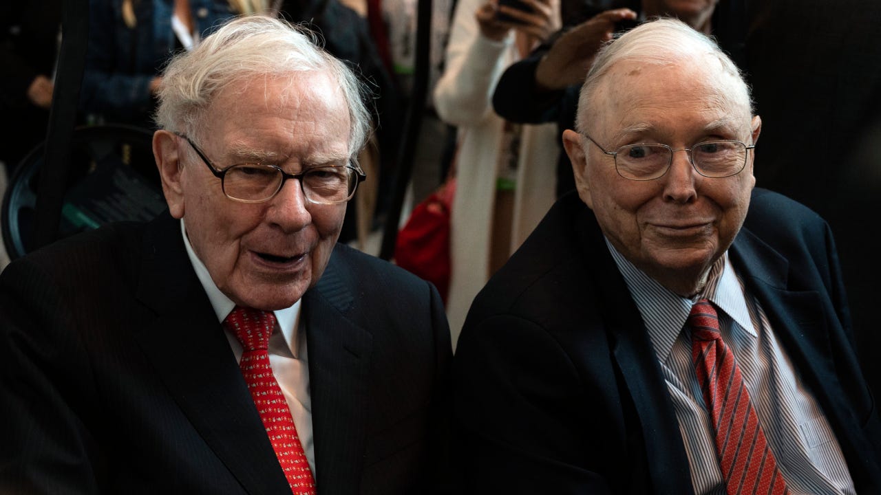 Warren Buffett and Charlie Munger attend a shareholders meeting