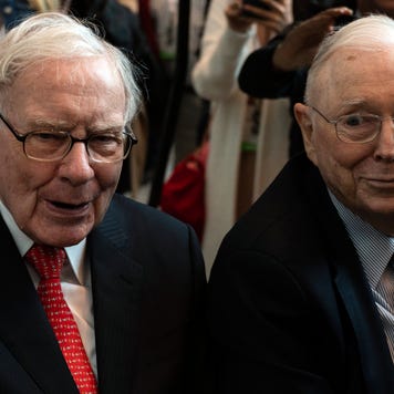 Warren Buffett and Charlie Munger attend a shareholders meeting