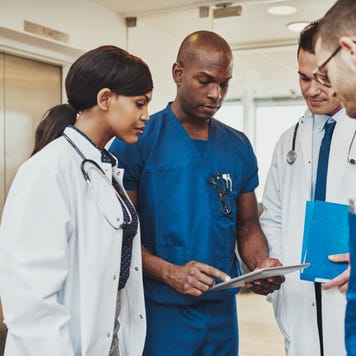Group of doctors and nurses discuss paperwork