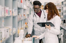 Two pharmacists look through medications