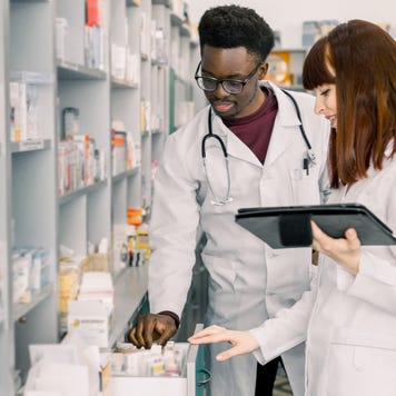 Two pharmacists look through medications