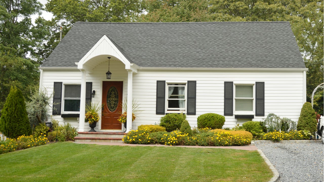 A single-story home with yard and driveway