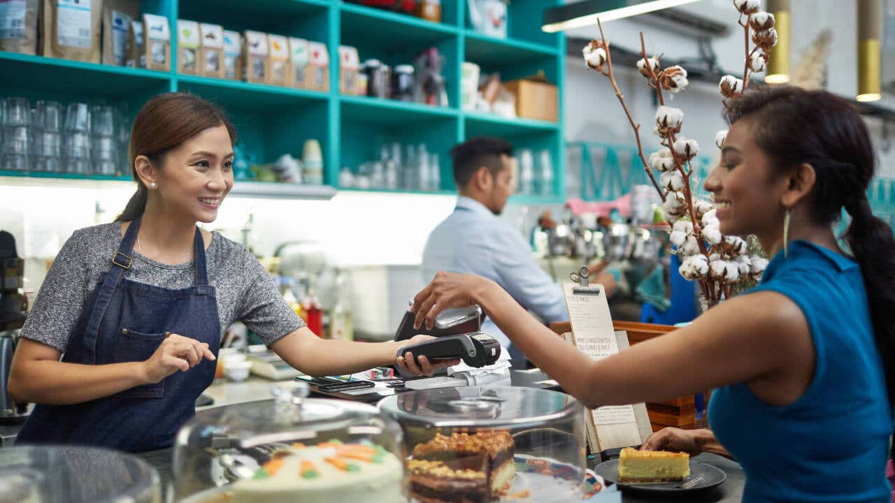 Shop owner taking credit card payment