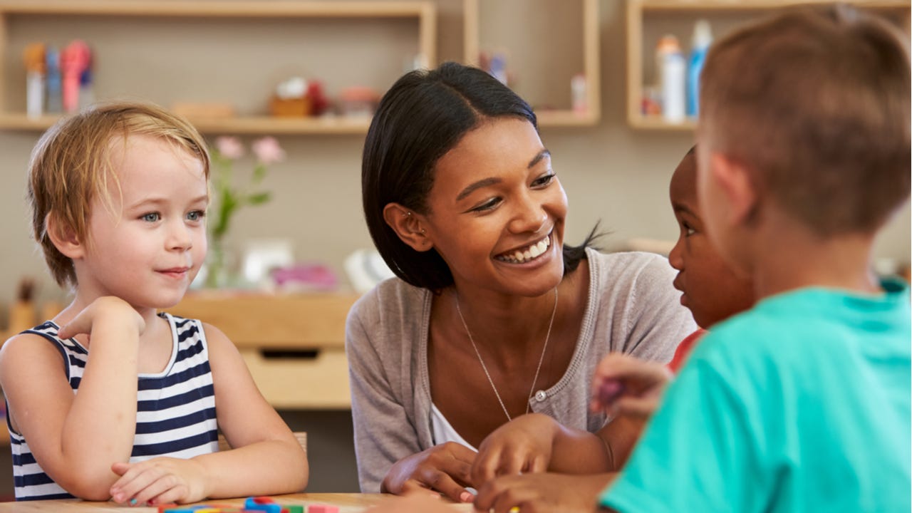 Elementary school teacher working with students