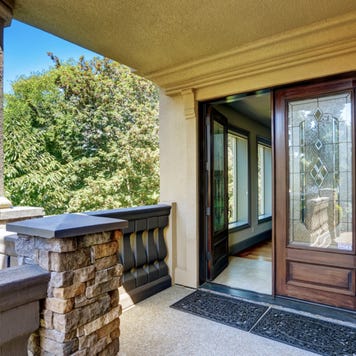 A double-door entryway with front porch and an open door