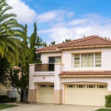 A Mediterranean-style single-family home with landscaping