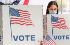 Woman voting in a face mask at the polls